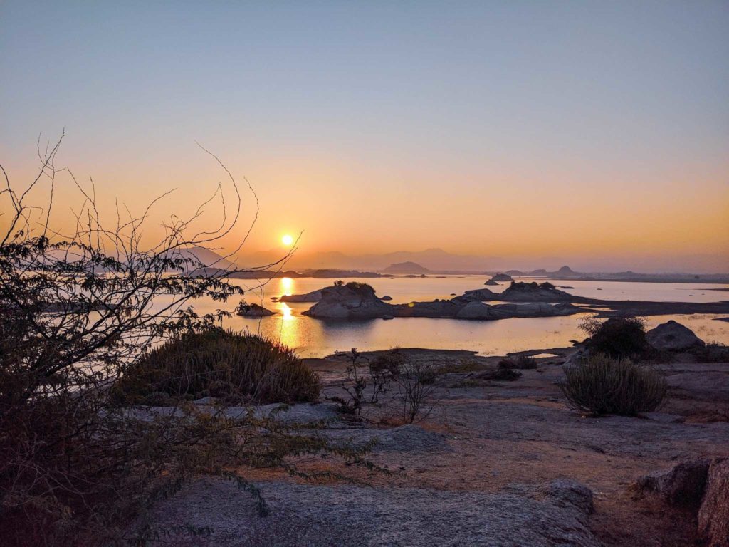 Sunset reflected in the water among Rajasthan’s rocky hills